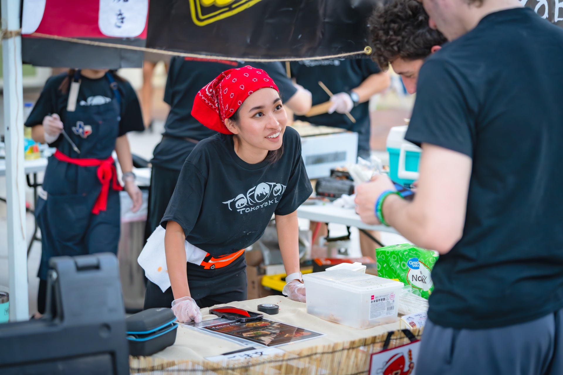 Takotama crew member greeting a customer