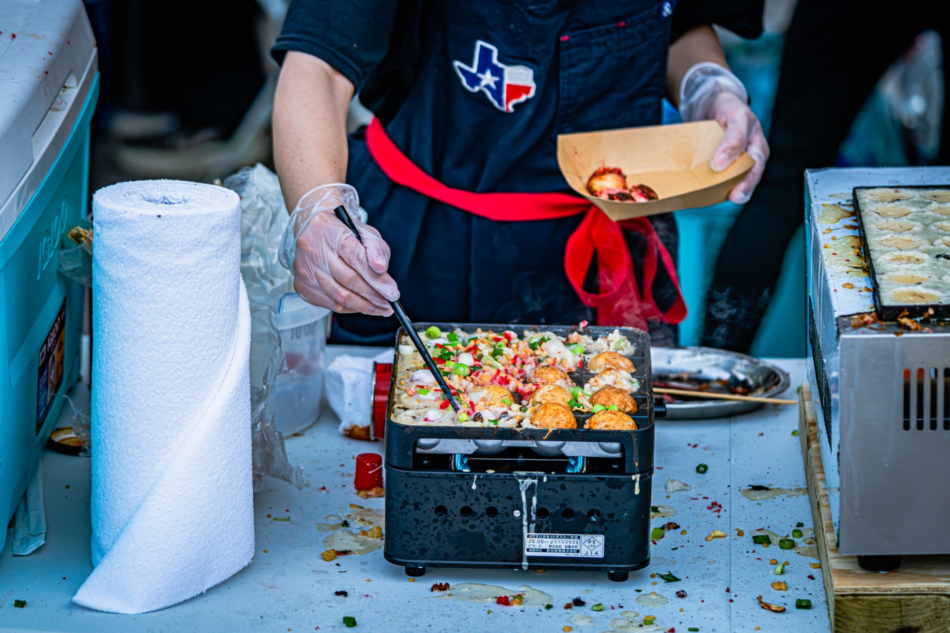 Fresh takoyaki topped with scallions and chili